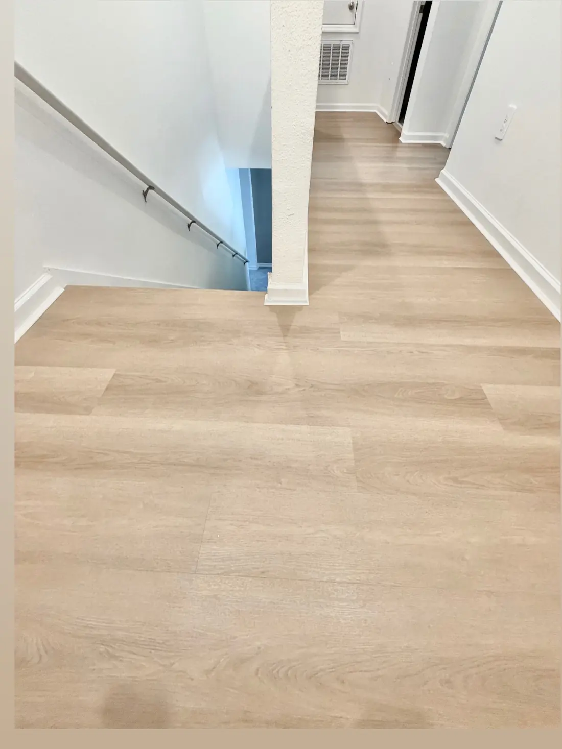 Pale wood-look LVP flooring on the landing and hallway in Celebration